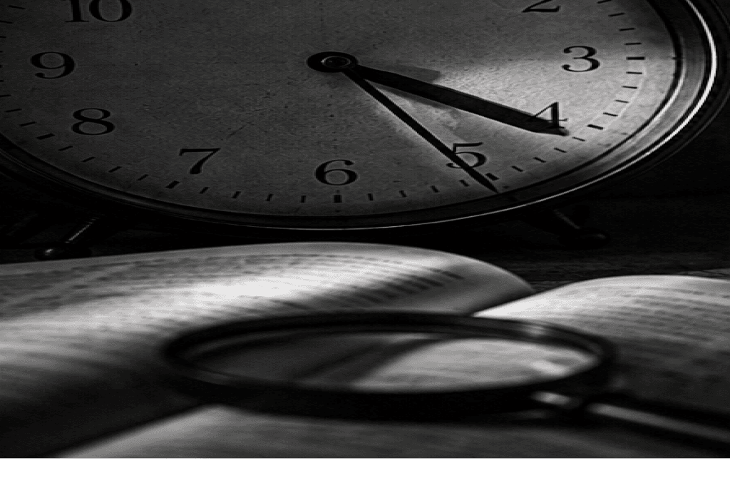 A large clock face with an open book and magnifier beneath it